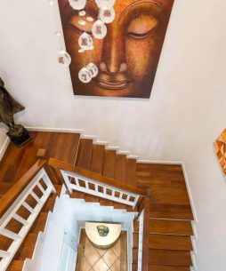 Wooden stairs with thai painting on the wall